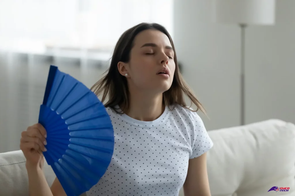 How to Prevent AC Breakdowns This Summer - woman with fan and no AC